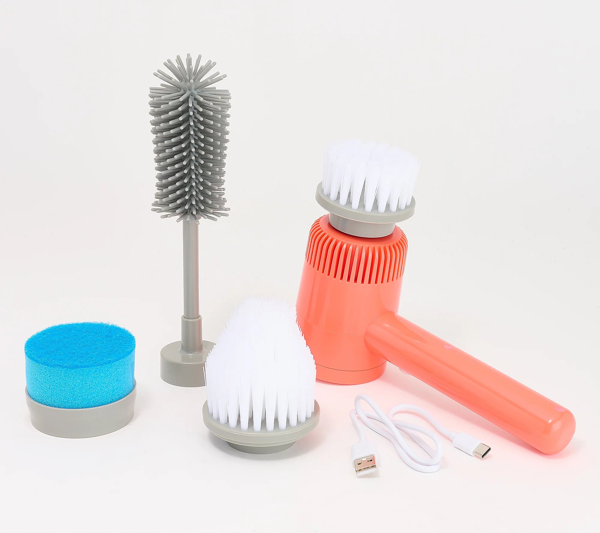 A portable handheld electric cleaning brush set on a white background, featuring a coral orange body, white bristles, a gray handle, a gray bottle-cleaning brush, a blue sponge, and a white charging cable.